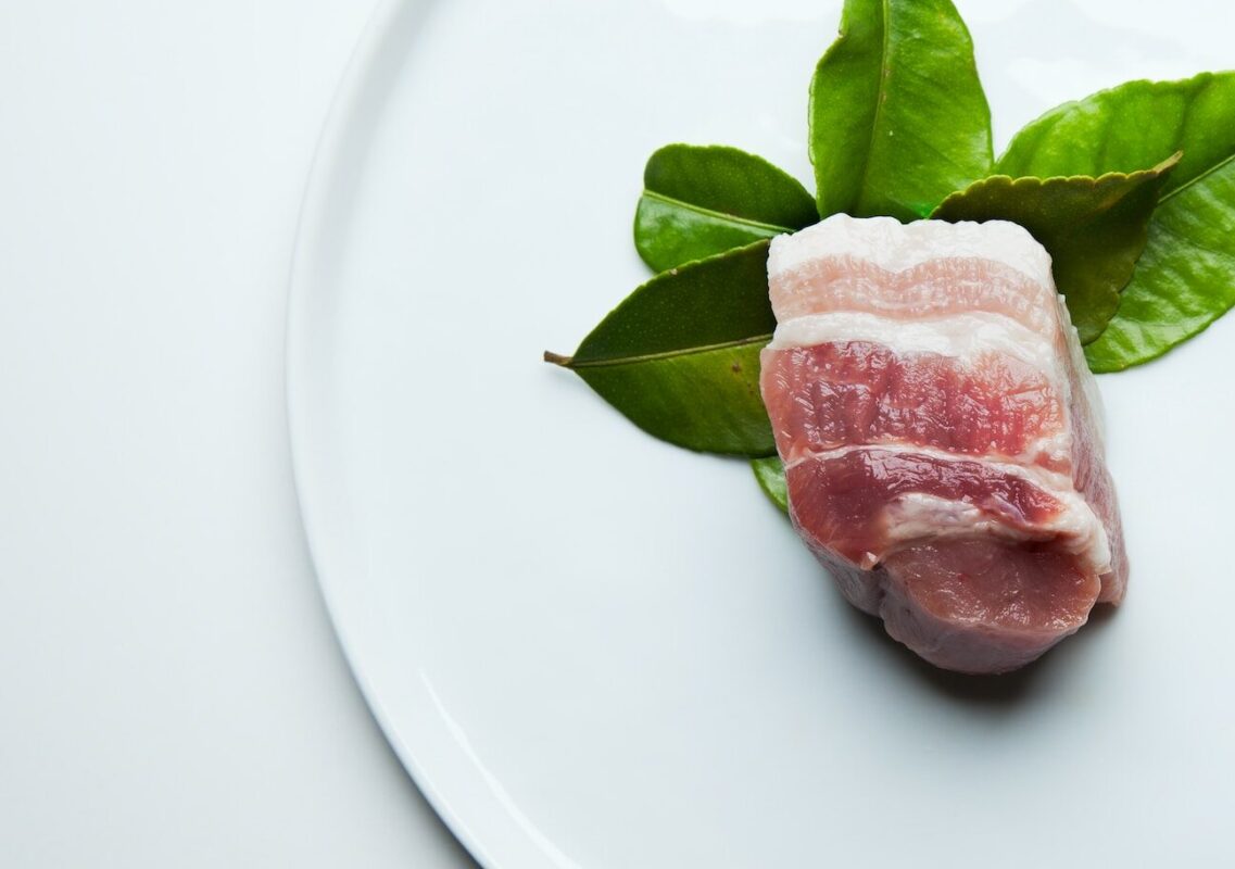 raw meat on white ceramic plate